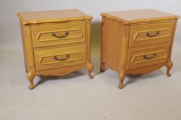 A pair of oak bedside chests with shaped tops and two drawers, raised on cabriole supports, 23" x