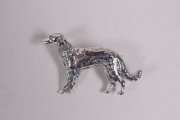 A sterling silver brooch in the form of a dog, 1"