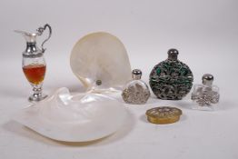 Three glass scent bottles with pierced white metal decorative mounts, a perfume bottle in the form