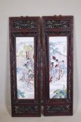 A pair of Chinese porcelain plaques with enamel decoration, mounted in carved and pierced hardwood