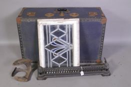 A travel trunk, a cast iron fender, a boot last and a stained glass window