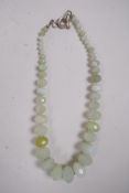 A graduated string of faceted green jade beads, 20" long