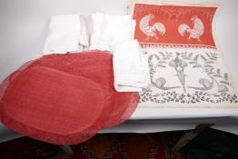 A collection of embroidered and printed linen and other fabric place mats