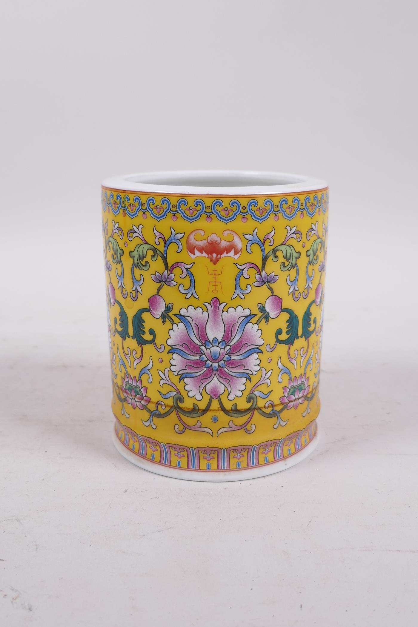 A Chinese yellow ground porcelain brush pot with polychrome lotus flower decoration, seal mark to - Image 4 of 5