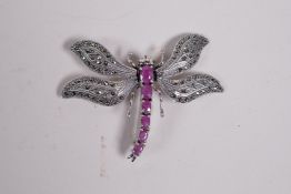 A 925 silver brooch in the form of a dragonfly with articulated wings set with marcasite, and the