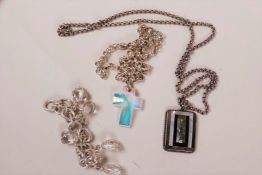 A silver chain and crystal crucifix pendant, a silver bracelet set with crystals and a silver