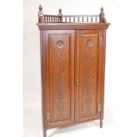 A Victorian Arts & Crafts walnut standing corner cupboard, with galleried top and two doors with
