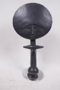 A West African akua carved wood doll on a metal stand, 11" high