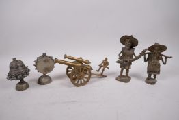 A collection of assorted metal items to include a brass table cannon, two Benin style figures and