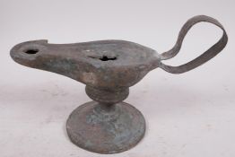 A Roman bronze oil lamp on pedestal base, 7" long