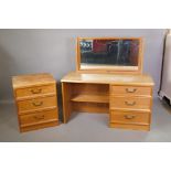A G-Plan three drawer mirror back dressing table and matching chest of three drawers, designed by E.