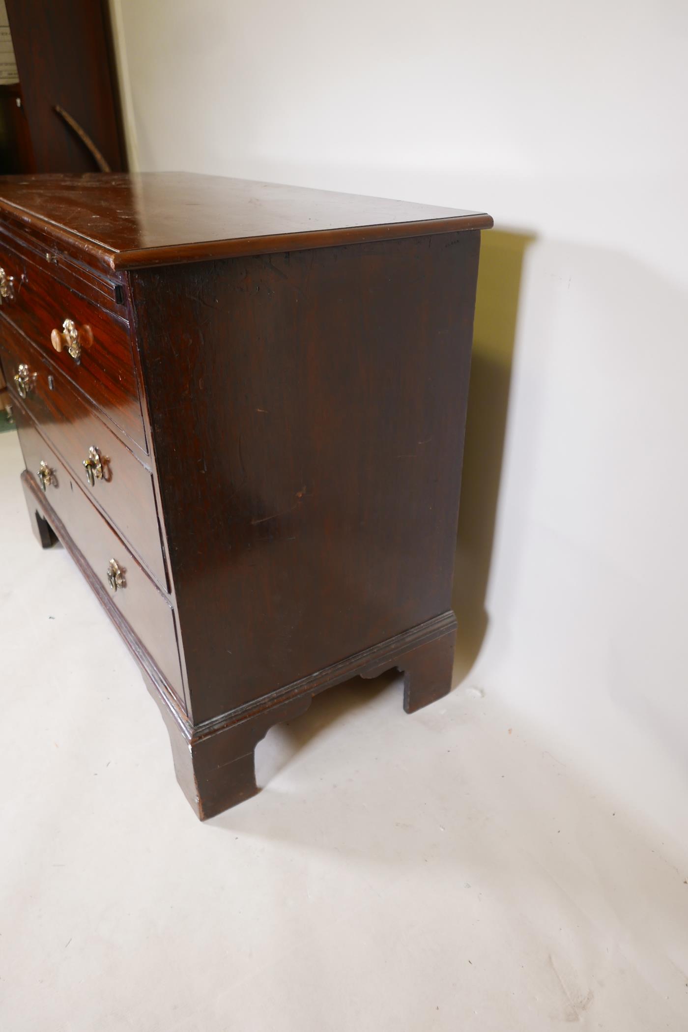 A C19th mahogany chest of three long drawers, under a brushing slide, raised on bracket supports, - Image 5 of 6