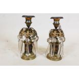 A pair of C19th bronze and ormolu mounted candlesticks with glass lustre drops and applied