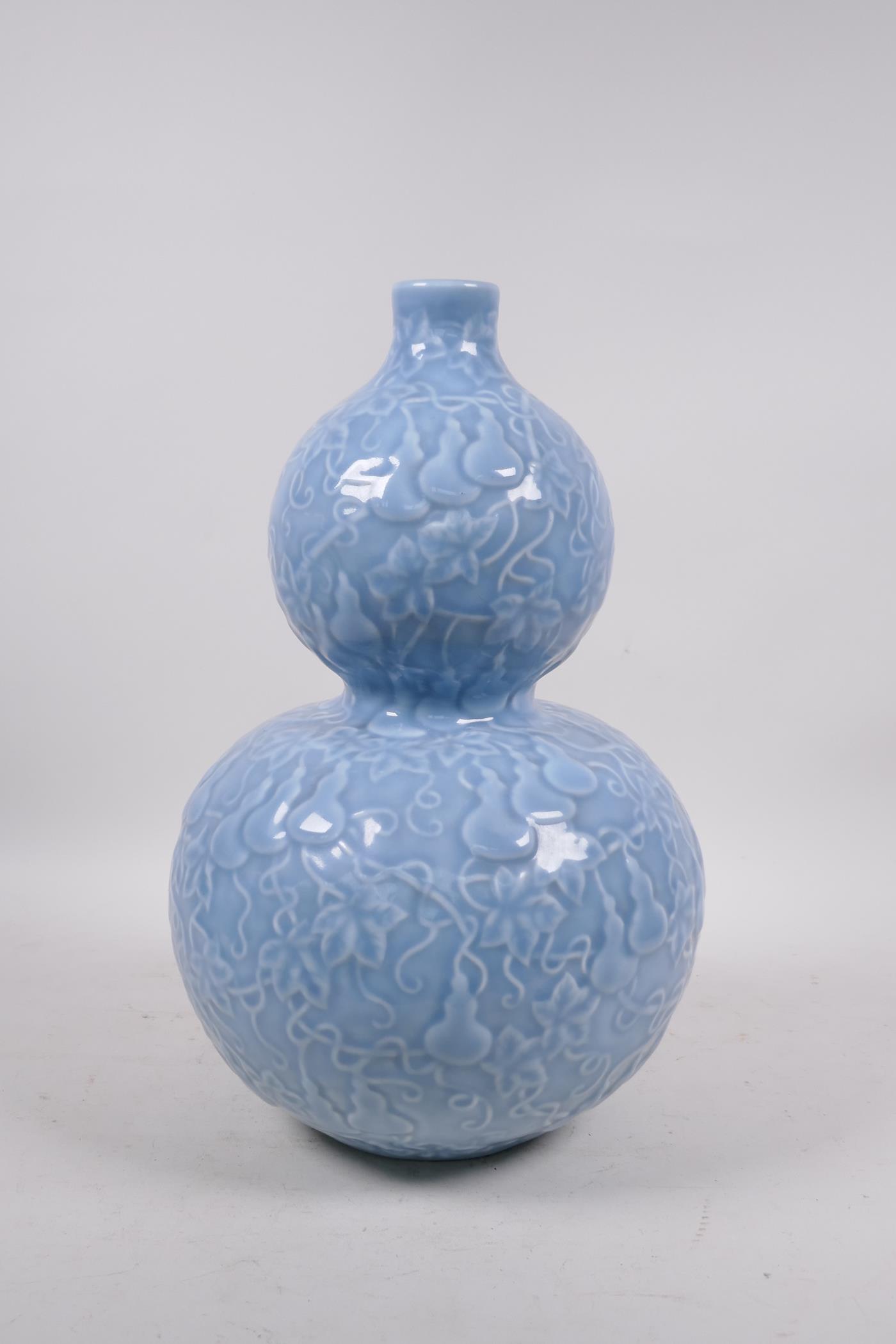 A Chinese light blue glazed porcelain double gourd vase with raised all over gourd vine - Image 4 of 5