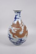 A Chinese Ming style blue and white pottery pear shaped vase with chased dragon decoration, 12½"