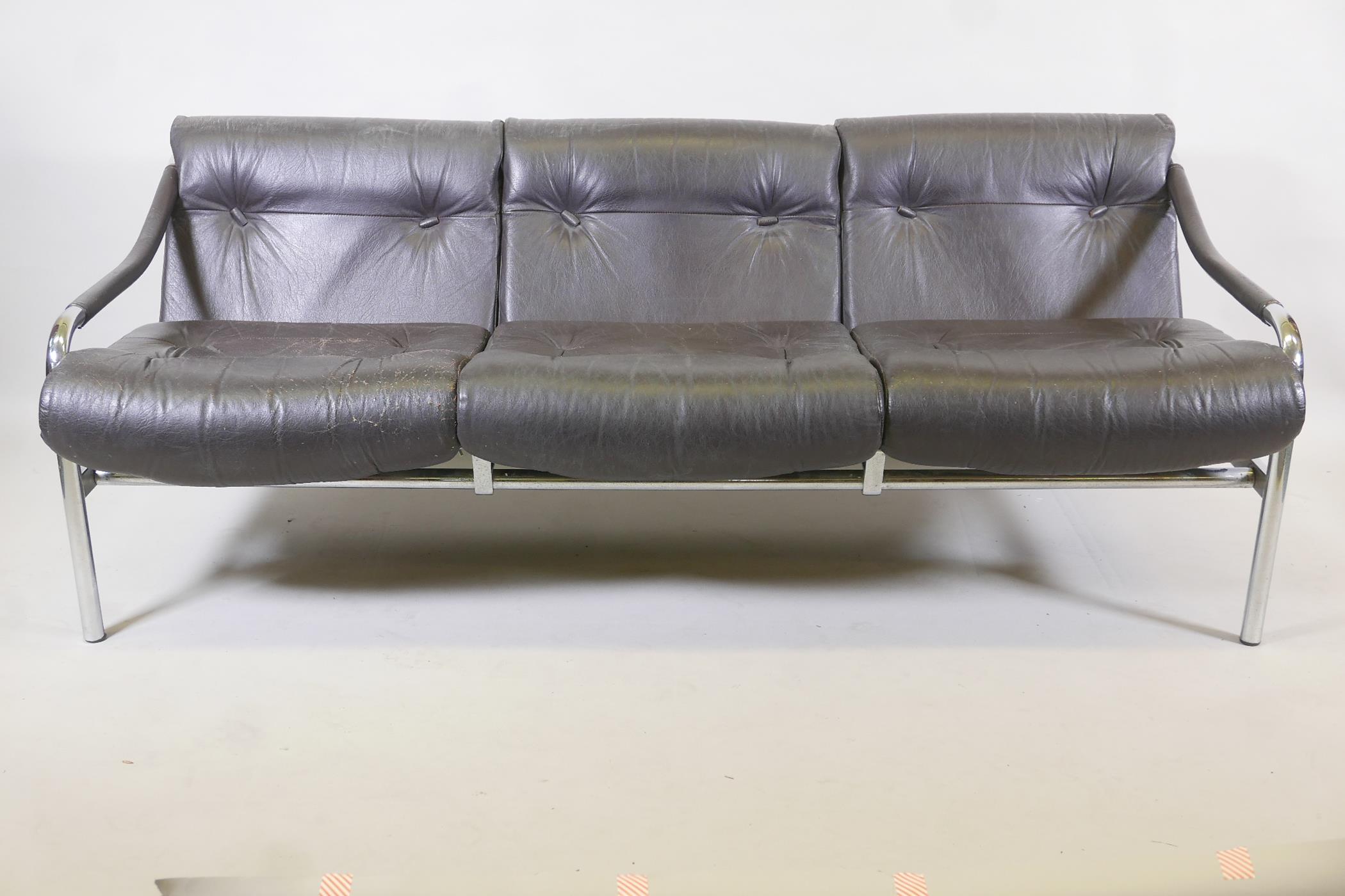 A 1970s Pieff 'Beta' leather and chrome three seat sofa designed by Tim Bates, 68" x 30", 27" high