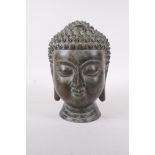 A Chinese bronze buddha head, 7" high