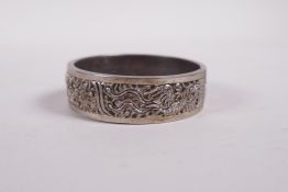 A Chinese reticulated white metal bangle with phoenix decoration, 2" diameter