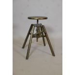 A bronzed metal adjustable bench stool