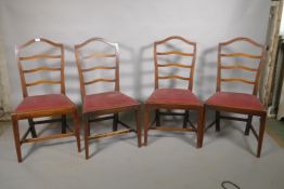 A set of four C19th mahogany ladder back chairs with drop in seats, 38" high
