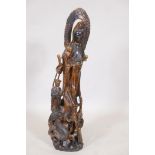 A carved wood figure of Quan Yin with attendants, 31" high