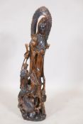 A carved wood figure of Quan Yin with attendants, 31" high