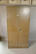 A mid century enamelled metal two door storage cupboard, 35" x 18", 71" high