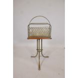 A late C19th/early C20th brass and oak revolving magazine rack, raised on splay supports, 14" x 6" x