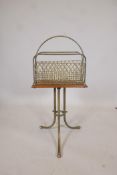 A late C19th/early C20th brass and oak revolving magazine rack, raised on splay supports, 14" x 6" x