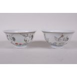 A pair of early C20th Chinese polychrome porcelain tea bowls decorated with cranes, seal mark to