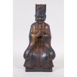 A Chinese gilt brass figure of a nobleman, seated with hands clasped, seal mark verso, 9" high