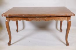 A French oak draw leaf dining table, with carved frieze and parquetry top, detachable legs, 39" x