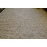 A silk and wool deep pile carpet with a repeating geometric design, silver grey on an off white