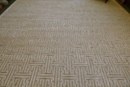 A silk and wool deep pile carpet with a repeating geometric design, silver grey on an off white