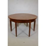 A Georgian inlaid mahogany demi lune dining table raised on square tapering supports, with extra
