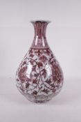 A Chinese red and white porcelain pear shaped vase with scrolling floral decoration, 12" high, A/F