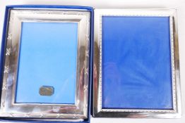 A sterling silver photo frame, aperture 7" x 5", together with a similar silver plated frame