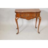 An C18th Dutch marquetry inlaid shaped top games table with single drawer, fold over top, the