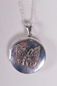 A 925 silver locket set with a butterfly, on a chain, 1½" drop