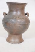 An African terracotta jar with ring handles, 11" high