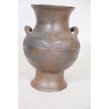 An African terracotta jar with ring handles, 11" high