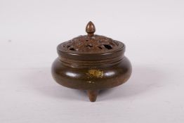 A Chinese gilt splash bronze censer and pierced cover, decorated with waterfowl in a lotus pond, six