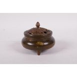 A Chinese gilt splash bronze censer and pierced cover, decorated with waterfowl in a lotus pond, six