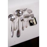 A hallmarked silver cigarette case, dessert spoon, tongs, caddy spoon and compact, (gross 235g)