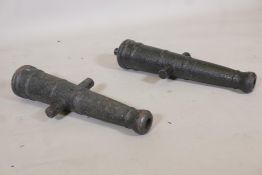 A pair of antique cast iron cannons, 23" long