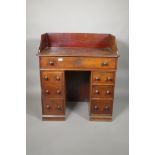 A C19th mahogany seven drawer kneehole desk with galleried top, 36" high, 32" wide, 20" deep