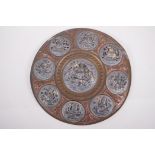 An Indian Tangore copper and brass wall plaque decorated with pressed and pierced white metal