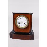 An ebonised and walnut cased mantle clock with two train movement striking on a bell, with white