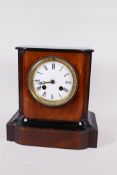 An ebonised and walnut cased mantle clock with two train movement striking on a bell, with white