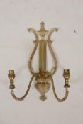 A gilt brass lyre shaped two branch wall sconce, 17" long